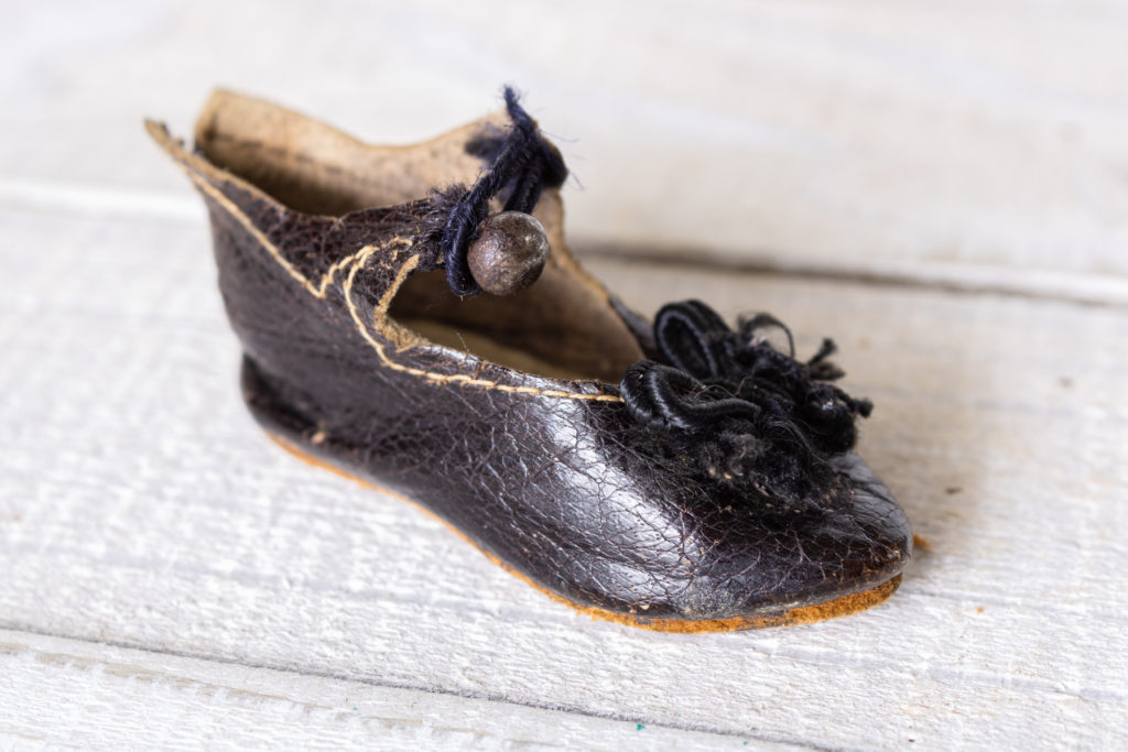 small antique leather french doll shoe marked "A La Tentation 22 Passage Vendome Paris"