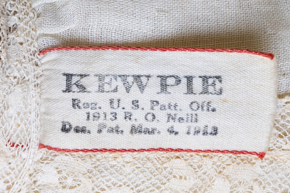 Cloth label found on antique Kewpie doll dress that reads "KEWPIE Reg. U. S. Patt. Off. 1913 R. O. neill Des. Pat. mar. 4, 1913."