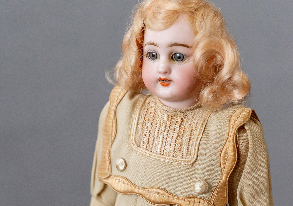 a Carl Hartmann Globe Baby bisque head doll in original early 20th century dress. In catalog she is a jointed, not a double jointed doll.